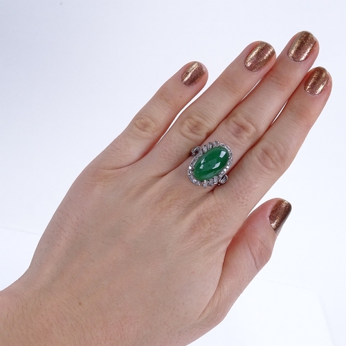 1120 - A cabochon jadeite and diamond cluster ring, set with large central cabochon jadeite, surrounded by ... 