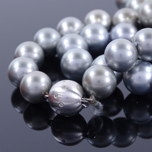 1127 - A single-row grey cultured South Sea pearl and diamond necklace, comprising a graduated row of 33 gr... 