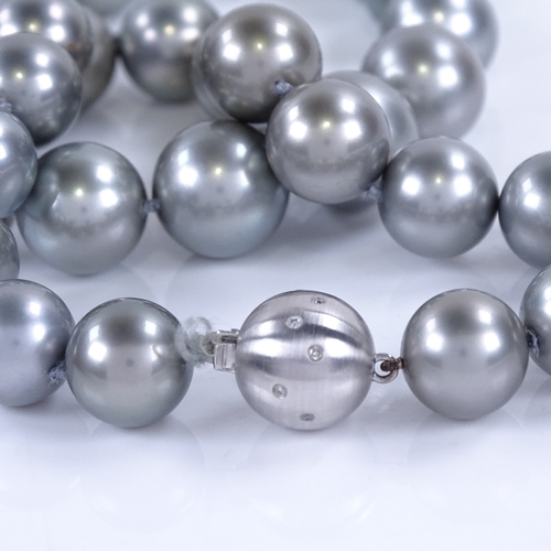 1127 - A single-row grey cultured South Sea pearl and diamond necklace, comprising a graduated row of 33 gr... 