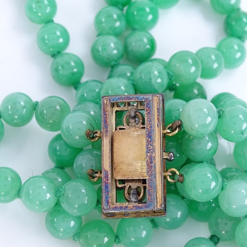 1133 - A double-row polished jade pearl and diamond necklace, 101 individually knotted jade beads measuring... 