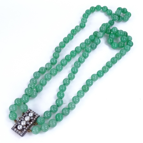 1133 - A double-row polished jade pearl and diamond necklace, 101 individually knotted jade beads measuring... 