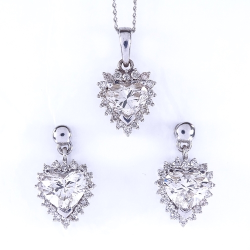 1135 - A heart shaped diamond cluster pendant necklace and stud earring demi-parure, set with central heart... 