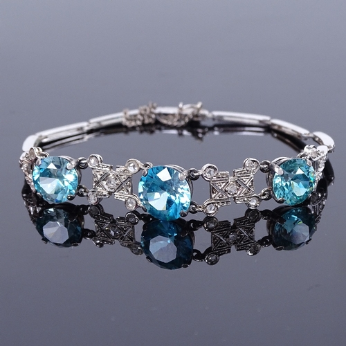 1136 - An 18ct white gold blue zircon and rose-cut diamond bracelet, Art Deco geometric form, set with grad... 