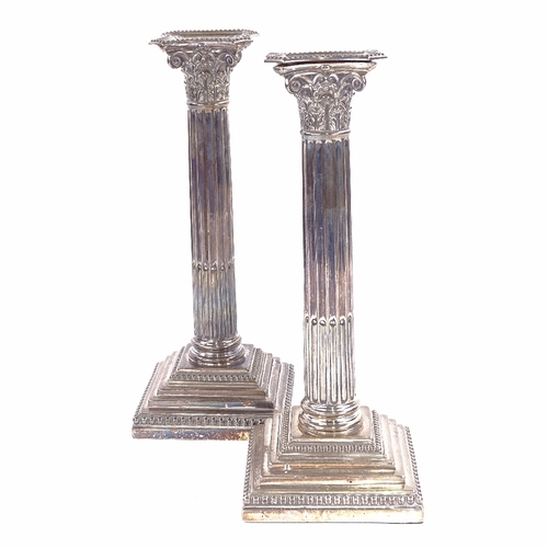 1141 - A pair of George V silver Corinthian column table candlesticks, stepped bases with removeable sconce... 