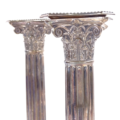 1141 - A pair of George V silver Corinthian column table candlesticks, stepped bases with removeable sconce... 