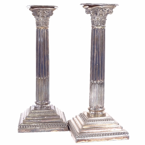 1141 - A pair of George V silver Corinthian column table candlesticks, stepped bases with removeable sconce... 