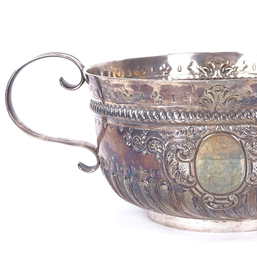 1142 - A Victorian silver 2-handled 3-pint punch bowl, formed as a 17th century porringer, half-fluted deco... 