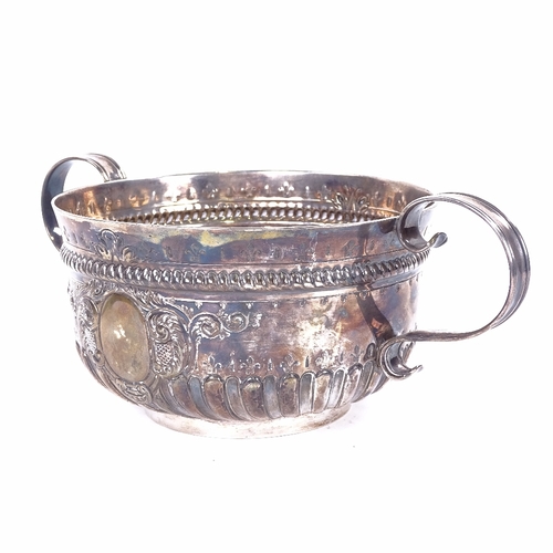 1142 - A Victorian silver 2-handled 3-pint punch bowl, formed as a 17th century porringer, half-fluted deco... 