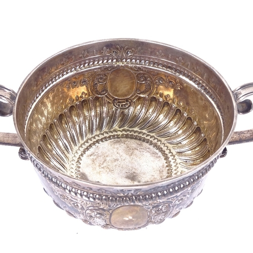 1142 - A Victorian silver 2-handled 3-pint punch bowl, formed as a 17th century porringer, half-fluted deco... 