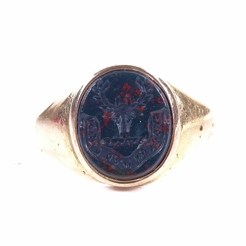 1155 - A 19th century unmarked gold bloodstone seal signet ring, intaglio carved stag-head emblem with mott... 