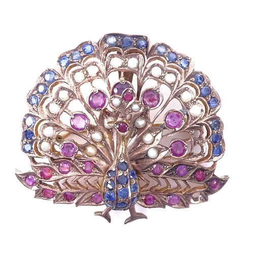 1158 - An Indian unmarked yellow metal ruby sapphire and pearl peacock pendant/brooch, pendant height 45.3m... 