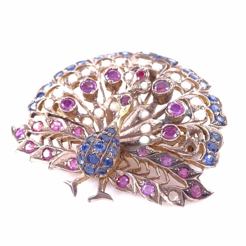 1158 - An Indian unmarked yellow metal ruby sapphire and pearl peacock pendant/brooch, pendant height 45.3m... 