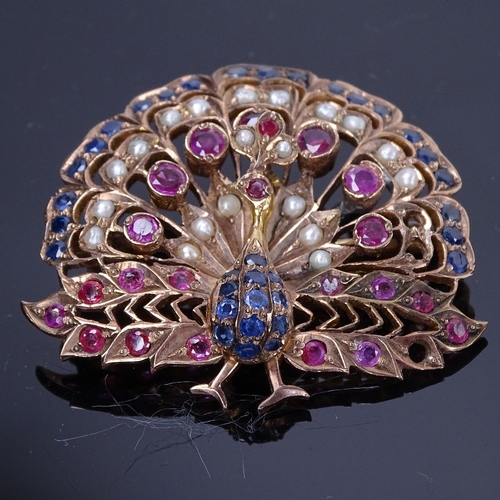 1158 - An Indian unmarked yellow metal ruby sapphire and pearl peacock pendant/brooch, pendant height 45.3m... 