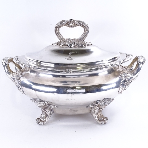 1619 - A large silver plated 2-handled soup tureen and cover, with cast foliate decoration on scrolled acan... 