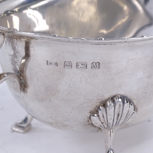 1627 - A George VI silver sauce boat, with engraved rim on 3 shell feet with scrolled acanthus leaf C-handl... 