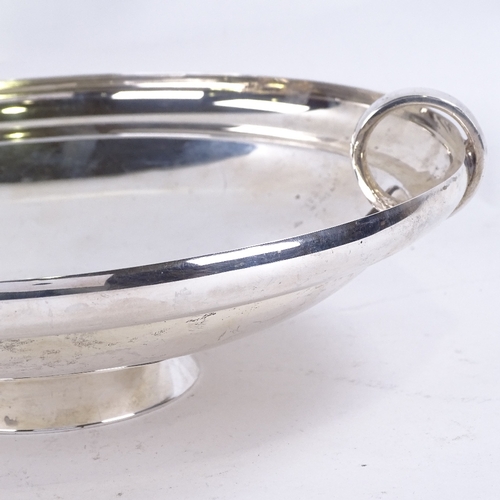 1629 - A George VI Art Deco circular silver table centre fruit bowl, plain circular form with ring handles,... 