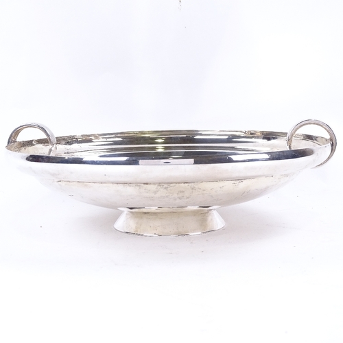 1629 - A George VI Art Deco circular silver table centre fruit bowl, plain circular form with ring handles,... 