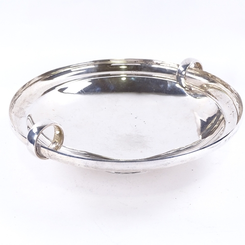 1629 - A George VI Art Deco circular silver table centre fruit bowl, plain circular form with ring handles,... 