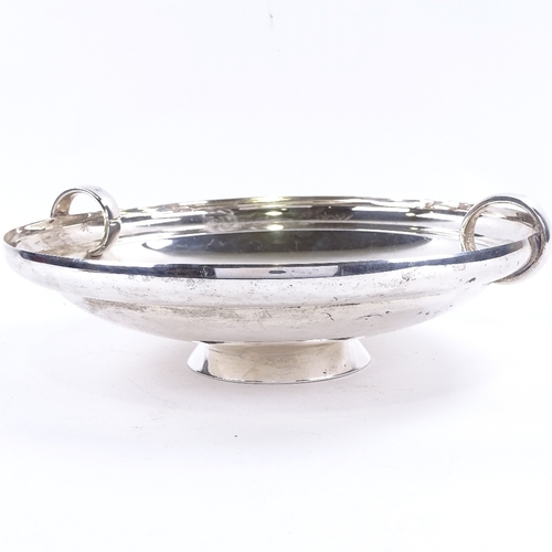 1629 - A George VI Art Deco circular silver table centre fruit bowl, plain circular form with ring handles,... 