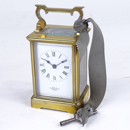 1067 - A brass-cased carriage clock timepiece, examined by Mappin & Webb, white enamel dial with Roman nume... 