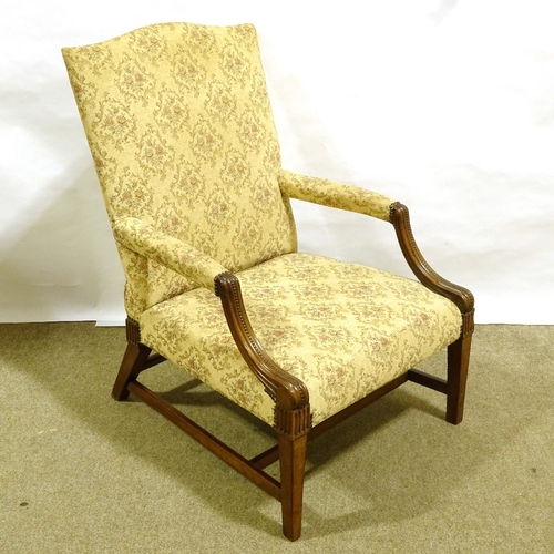 205 - An early 19th century carved mahogany-framed open arm Gainsborough style library chair