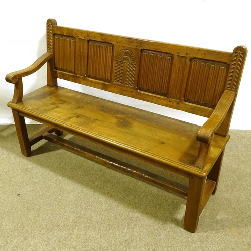 243 - A 19th century golden oak hall settle, with linenfold carved and panelled back, length 142cm