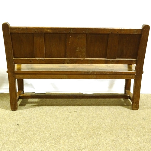 243 - A 19th century golden oak hall settle, with linenfold carved and panelled back, length 142cm