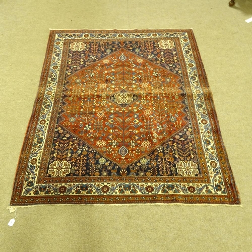 286 - A handmade Abadeh floral decorated rug, 207cm x 158cm.