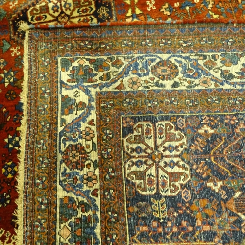 286 - A handmade Abadeh floral decorated rug, 207cm x 158cm.