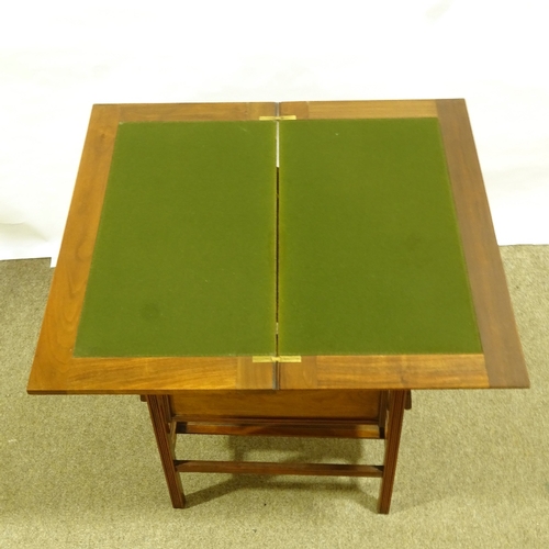 345 - A Victorian Aesthetic Movement fold over table, with fold-out shelves below, 71cm x 38cm