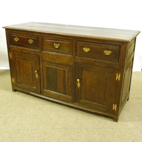 387 - An 18th century panelled oak dresser base, with 3 frieze drawers and panelled cupboards under, lengt... 