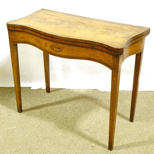 391 - A Georgian satinwood and tulip wood crossbanded fold over card table, with serpentine front and inla... 