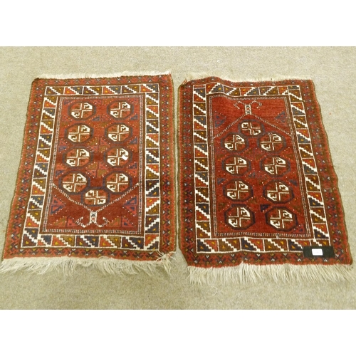 396 - A pair of handmade Persian red ground rugs, 95cm x 70cm.