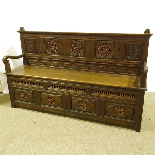 399 - A 19th century French oak hall settle, with inset bobbin turned spindles and rising seat, length 182... 