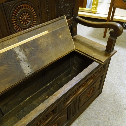 399 - A 19th century French oak hall settle, with inset bobbin turned spindles and rising seat, length 182... 