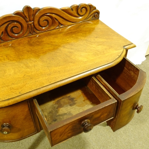 451 - A Victorian mahogany bow-front sideboard of small size, with carved back, 3 frieze drawers and spira... 