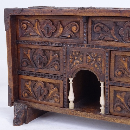 299 - A small 19th century relief carved wood table-top chest of drawers with ivory columns, width 25cm