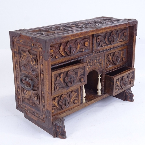 299 - A small 19th century relief carved wood table-top chest of drawers with ivory columns, width 25cm