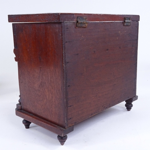 302 - A small Victorian mahogany table-top cabinet in the form of a chest of drawers, with rising lid and ... 