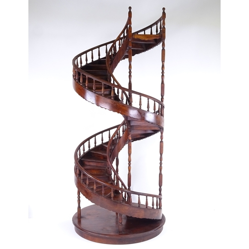 305 - A large mahogany spiral staircase design display stand, with spindled balustrade, late 20th century,... 