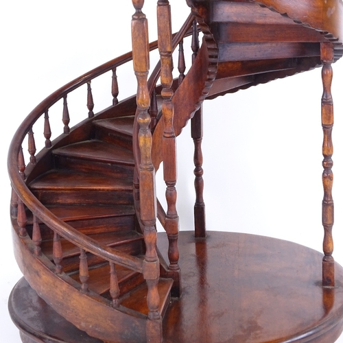 305 - A large mahogany spiral staircase design display stand, with spindled balustrade, late 20th century,... 