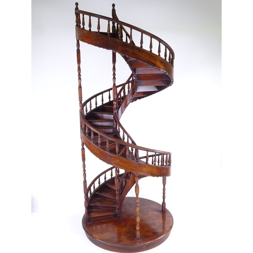 305 - A large mahogany spiral staircase design display stand, with spindled balustrade, late 20th century,... 