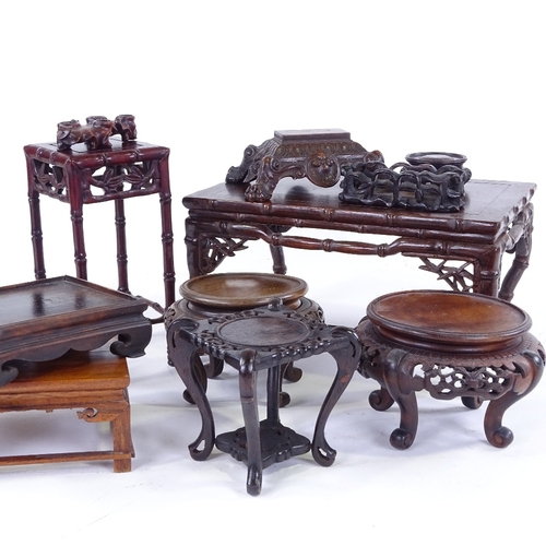 307 - A group of Chinese carved hardwood stands, largest 30cm across