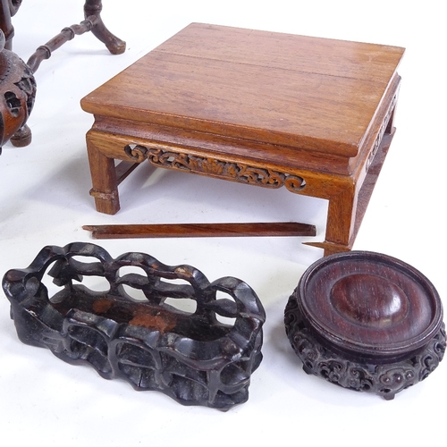 307 - A group of Chinese carved hardwood stands, largest 30cm across