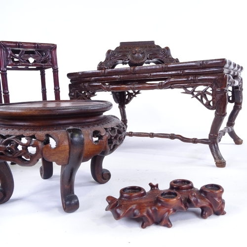 307 - A group of Chinese carved hardwood stands, largest 30cm across