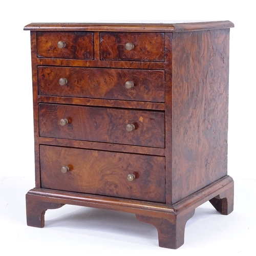 310 - A Victorian amboyna apprentice chest of drawers, with brass handles and bracket feet, width 22cm, he... 