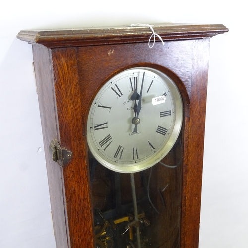 319 - An oak-cased synchronome electric wall clock with glazed door, height 127cm