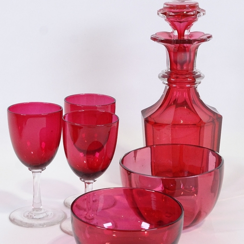 579 - A cranberry glass decanter, two cranberry glass finger bowls and three glasses, decanter height 23cm... 