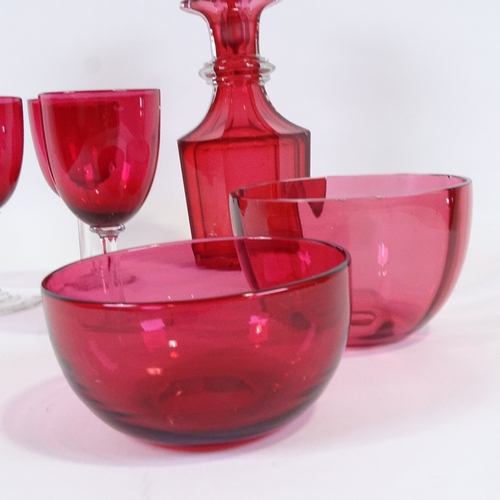 579 - A cranberry glass decanter, two cranberry glass finger bowls and three glasses, decanter height 23cm... 