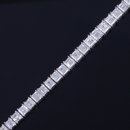 1112 - A baguette diamond tennis line bracelet, circa 1960, total diamond content approx 15ct, set with 50 ... 